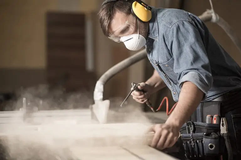 Worker using equipment in a woodworking workshop